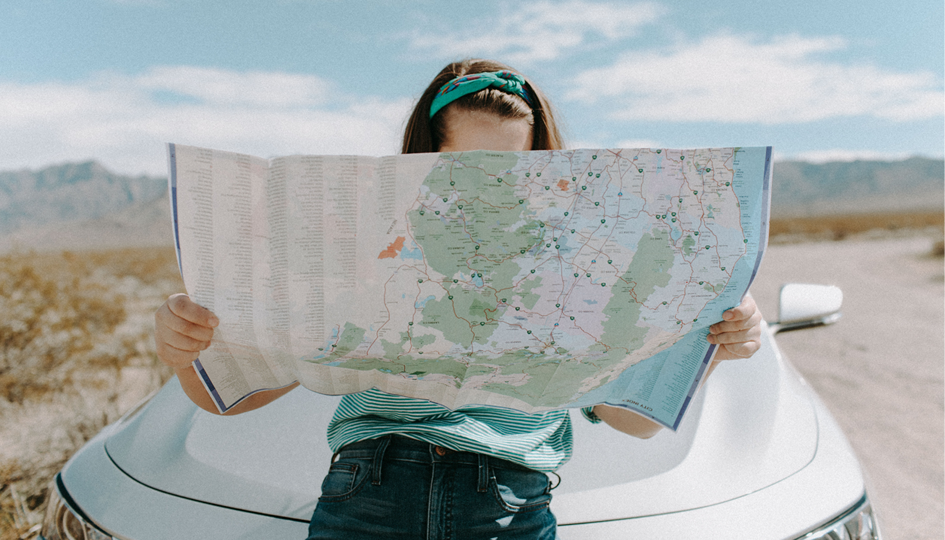 Woman Reading Map | Destination Vacation | Benefits by Design
