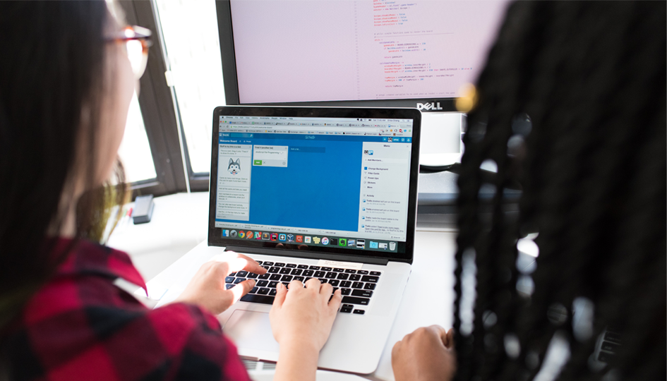 Two woman using a laptop computer | Online Benefits Administration | Benefits by Design