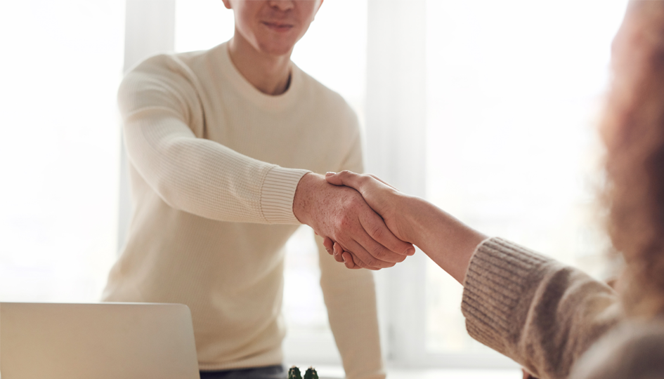 Man shaking woman's hand | Recruiting Top Talent | Benefits by Design