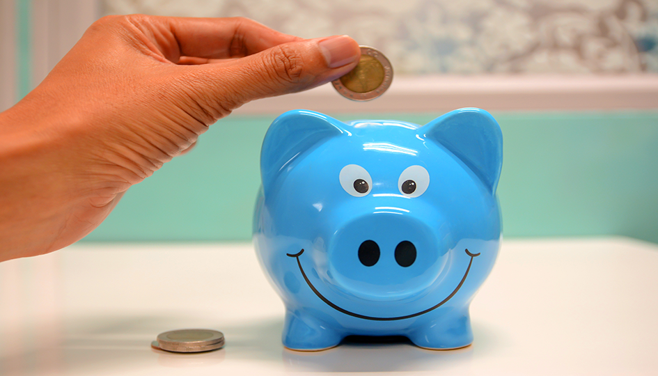 Blue Piggy Bank with a hand placing coins in | Spending Account | Benefits by Design