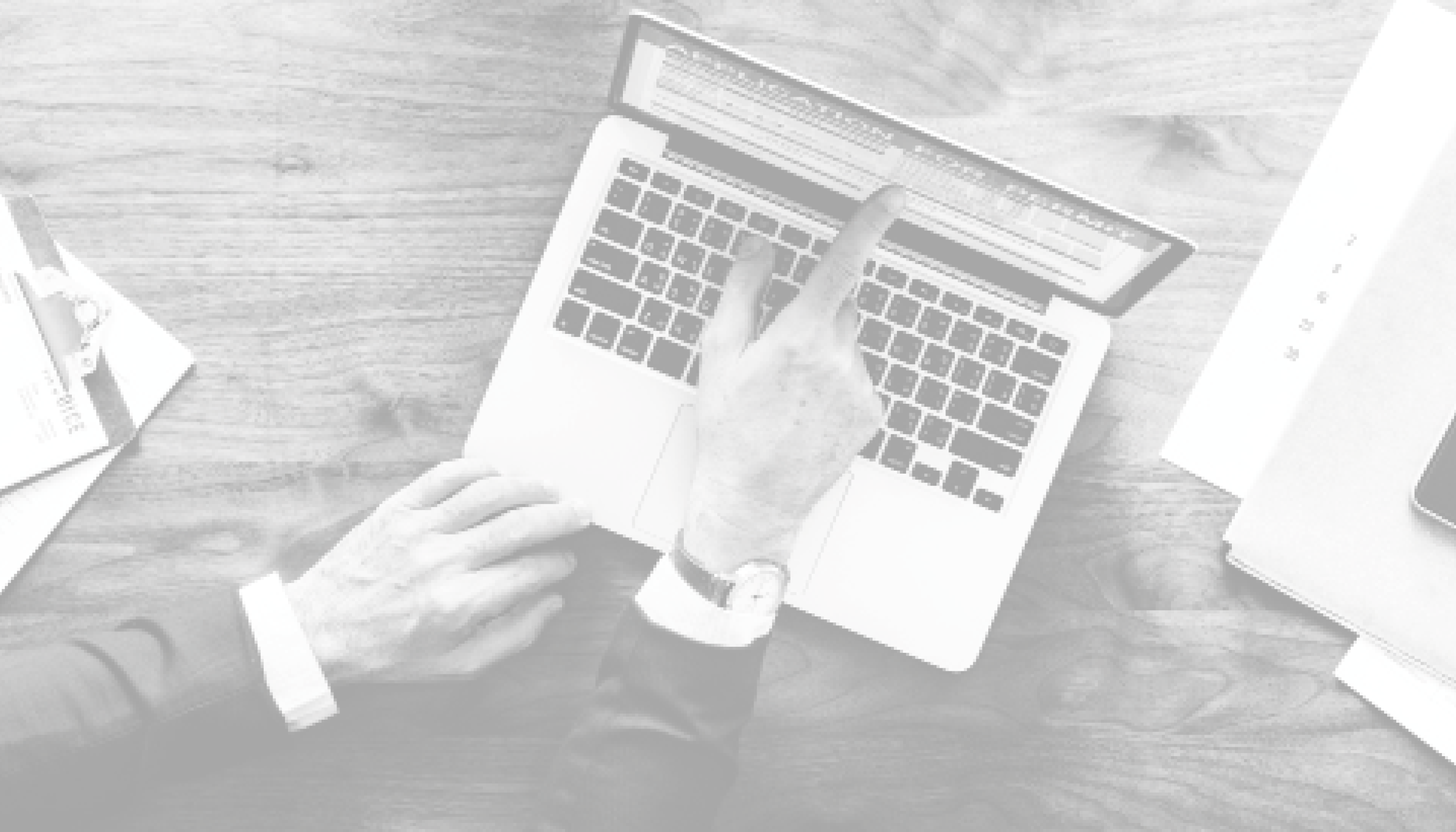 Man with computer pointing to the computer screen.