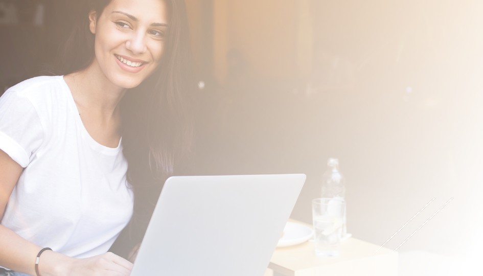 Woman smiling with a laptop in front of her