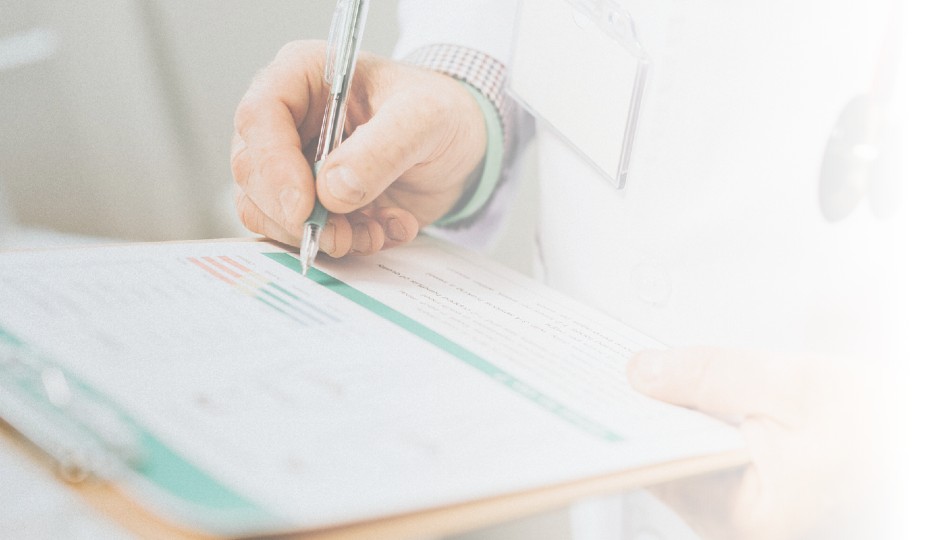 Writing on a clipboard with a pen | HCSA eligible expenses | Benefits by Design