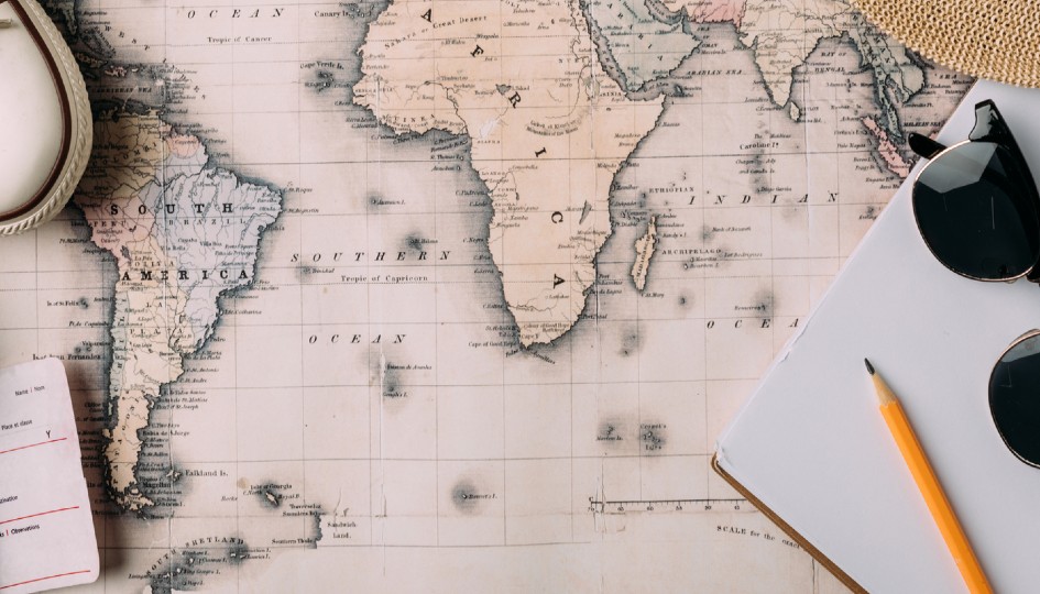 Map with a notepad and pen on top.