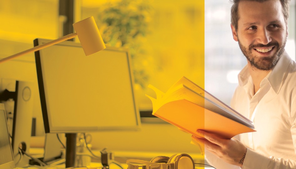 Man in front of computer with notebook open | Employee Assistance Program (EAP) | Benefits by Design