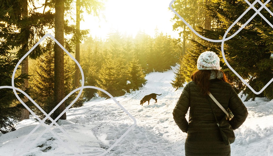 Woman walking her dog in the snow