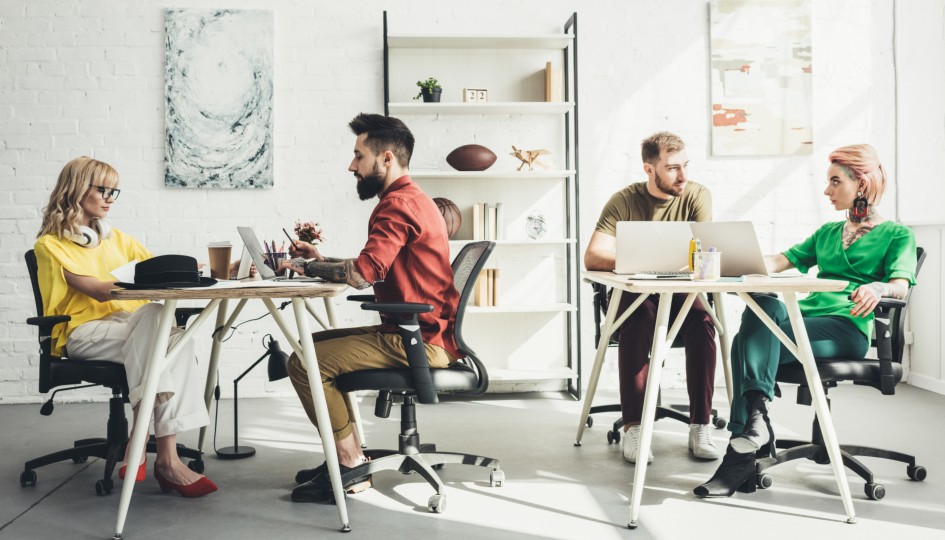 People working at desks in an office environment.