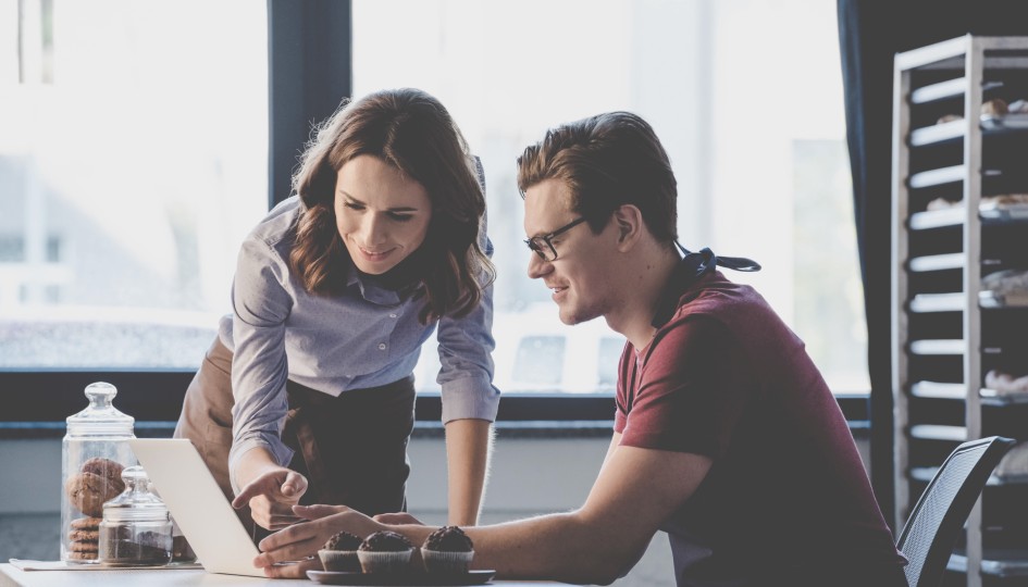 Man and a woman looking at a computer screen