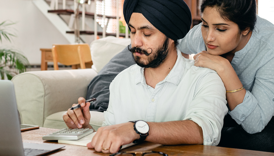 Man and woman reviewing documents | Tax time | Benefits by Design
