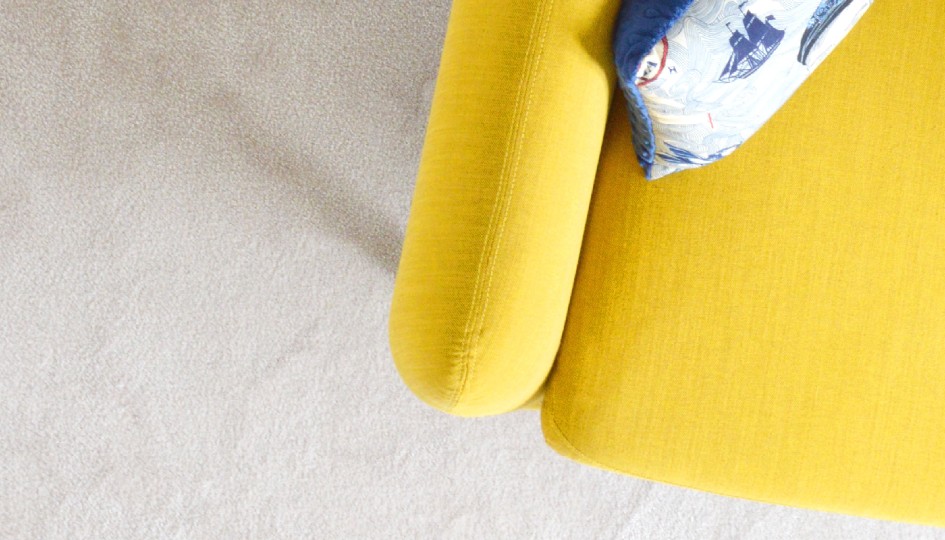 Yellow chair with a pillow on it