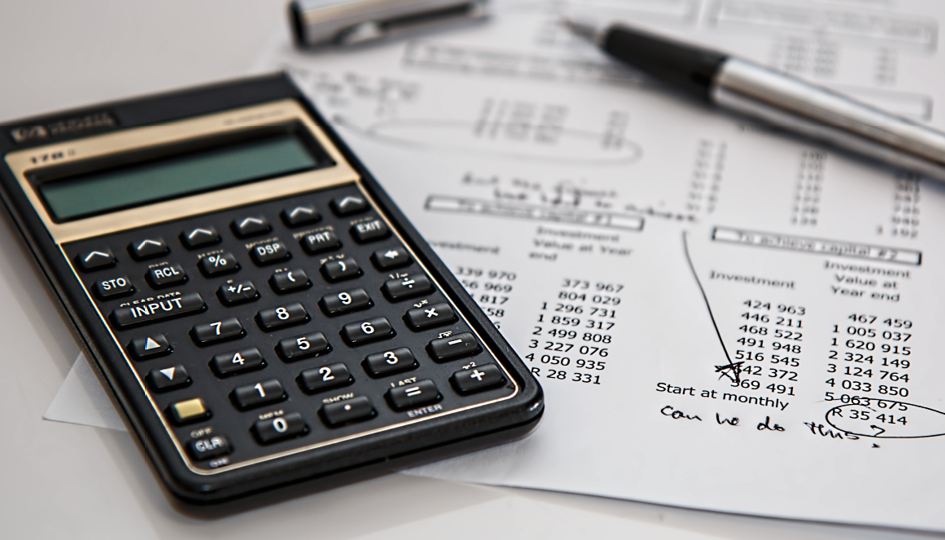 Calculator on a table of financial documents | Financial Wellness | Benefits by Design