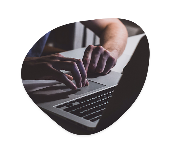 Man typing on a laptop.