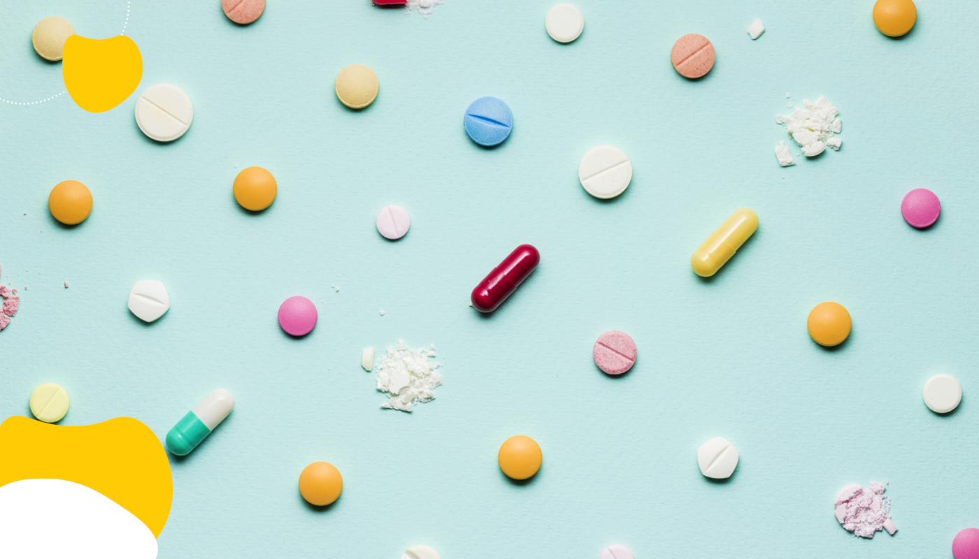 Scattered pills on a teal background | Health Insurance | Benefits by Design
