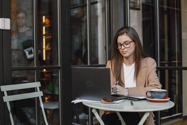 Happy woman working from a coffee shop