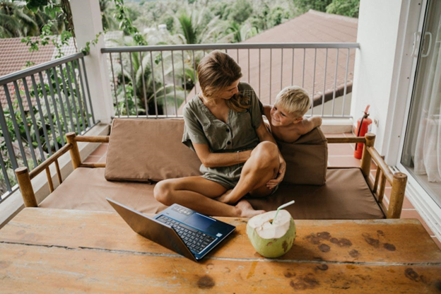 Woman working from home next to her child.